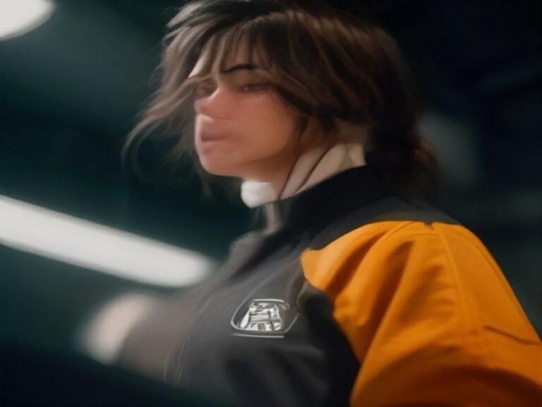 Quality control technician performing a thorough inspection of a finished football jacket in the manufacturing plant.